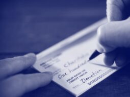 Writing check for charitable donation as part of your financial strategy