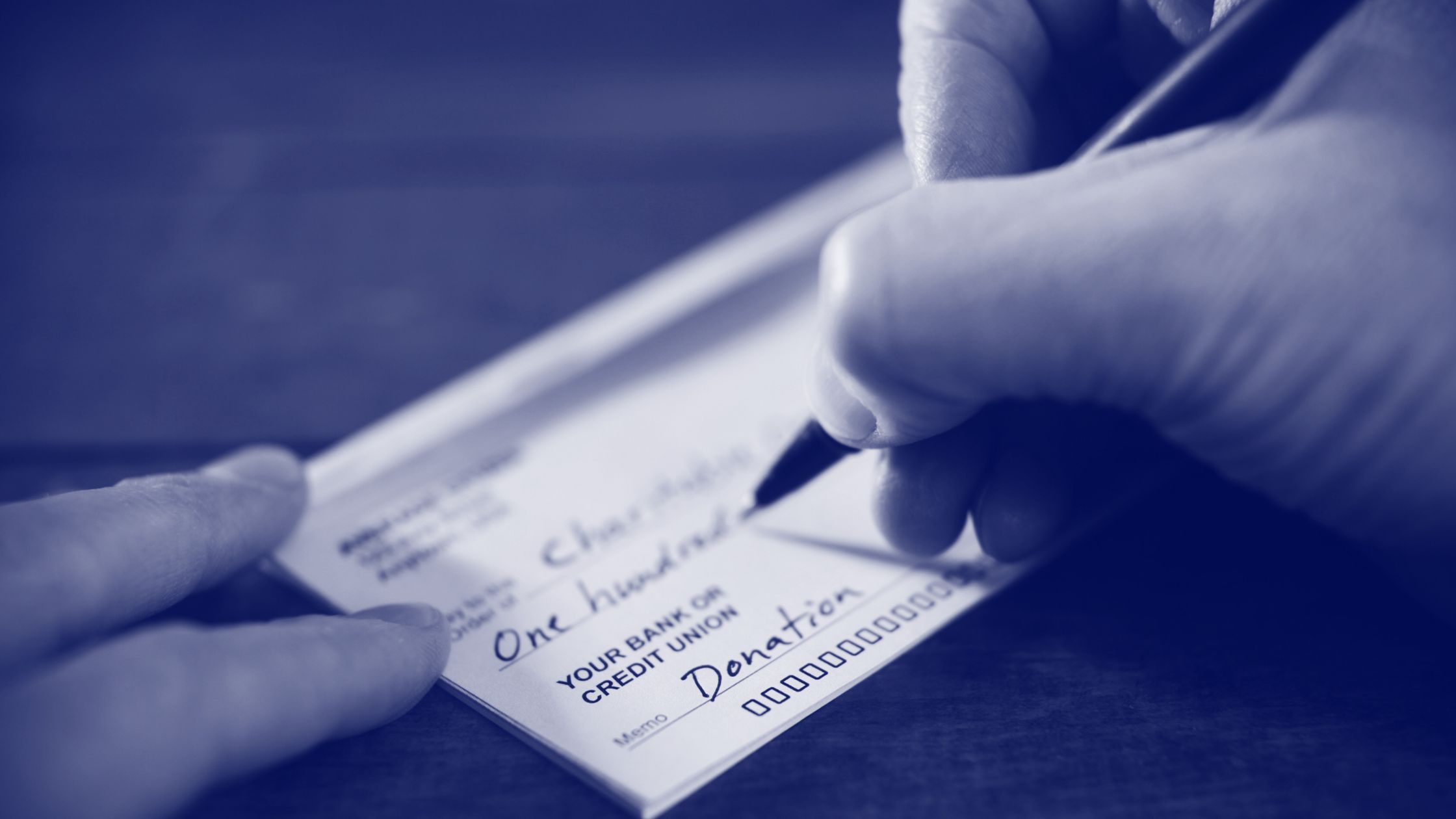 Writing check for charitable donation as part of your financial strategy